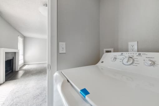a washer and dryer in a room with a fireplace