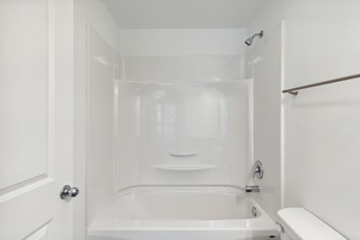 a bathroom with a shower and a sink and a bath tub