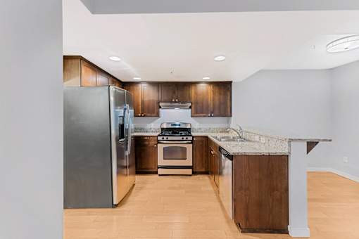 a kitchen with wooden cabinets and stainless steel appliances