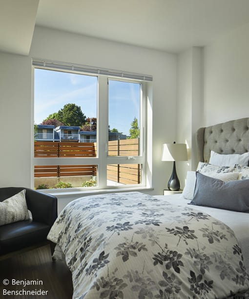 a bedroom with a large bed and a large window
