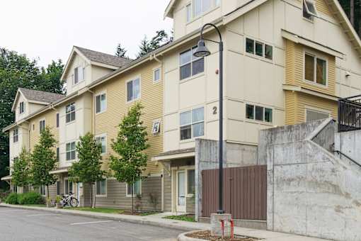 Apartment building with a bicycle parked in front.