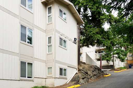 A white building with a yellow curb in front of it.