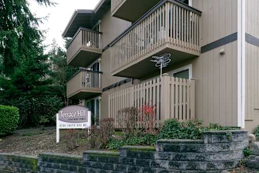 A sign in front of a building that says Terrace Hill.