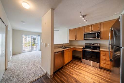 A kitchen with wooden cabinets and stainless steel appliances.