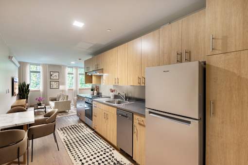 A kitchen with a refrigerator, sink, and dining table.