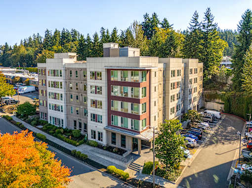A large building with a parking lot in front of it.