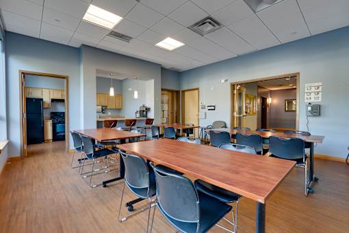 A conference room with a long table and chairs.