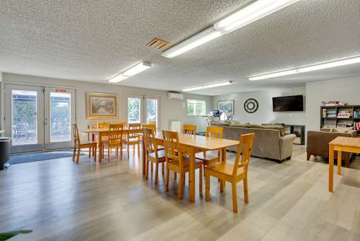 A dining room with wooden chairs and a table.