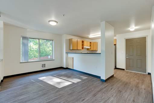 A room with a window, a door, and a countertop.
