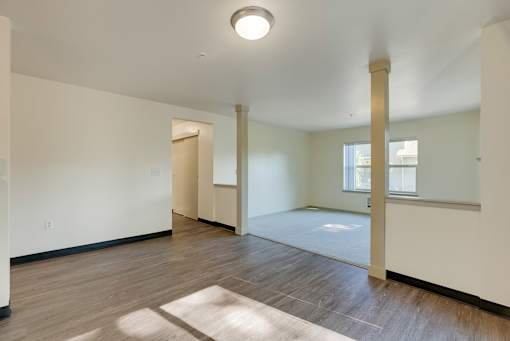 A room with a white ceiling and a window with a white frame.