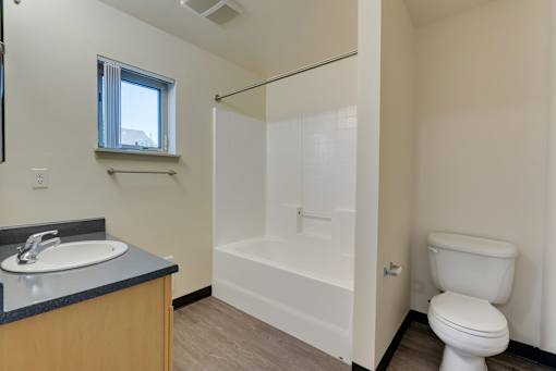 A bathroom with a toilet, sink, and bathtub.