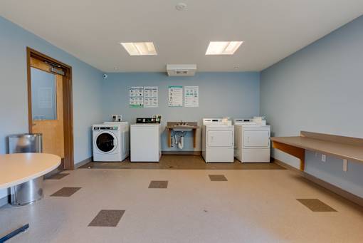 A laundry room with washers and dryers.