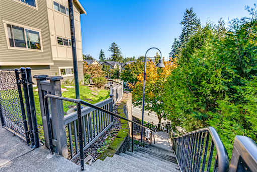 A staircase with a metal railing leads up to a building.