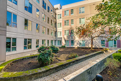 A building with a small garden in front of it.