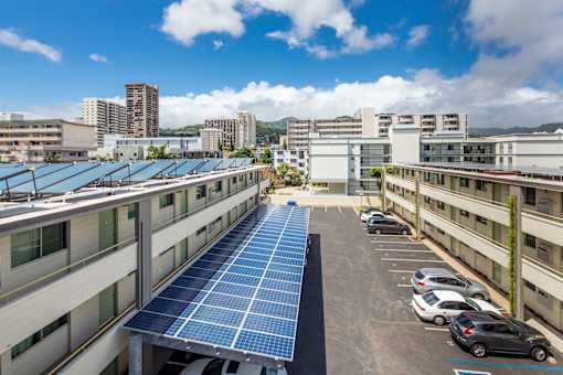A parking lot with solar panels on the roof.