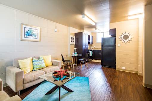A living room with a couch, chairs, and a coffee table.