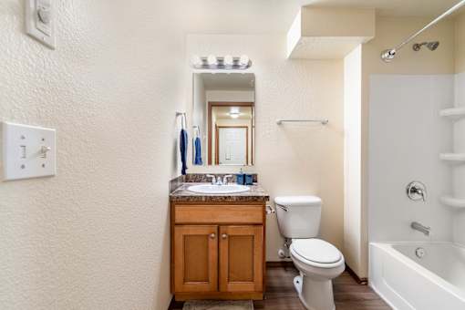 A bathroom with a toilet, sink, and bathtub.