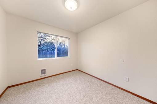 A room with a window showing a snowy scene outside.