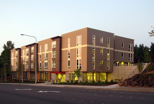 A large building with a lot of windows is lit up with yellow lights.