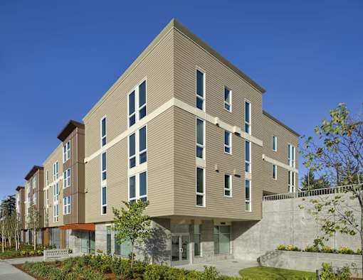 A modern building with a mix of beige and brown panels.