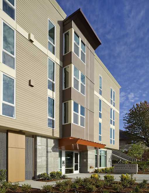 A modern building with a combination of beige and brown panels.