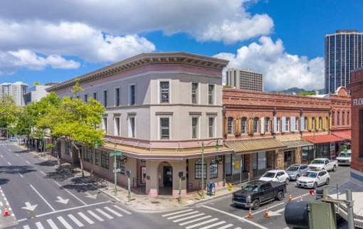 an old building on the corner of a city street