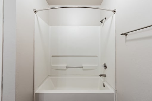 a bathroom with a white bathtub and a white shower curtain
