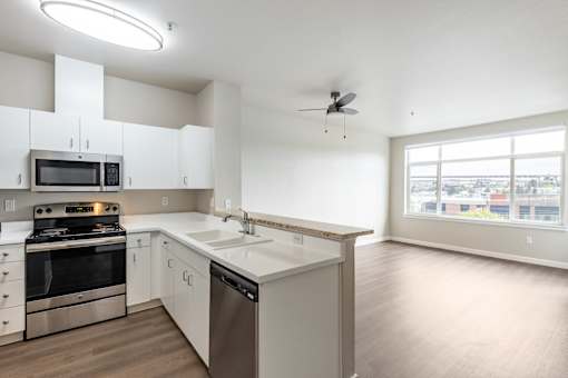 A modern kitchen with stainless steel appliances and white cabinets.
