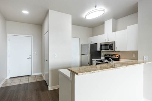 A kitchen with a stove, oven, and microwave.