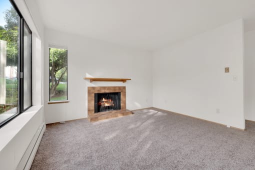 a living room with a fireplace and a window