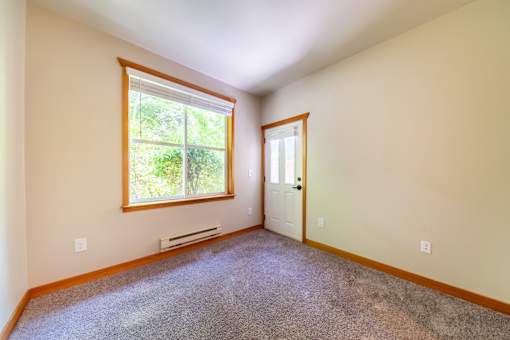 A room with a window and a door.