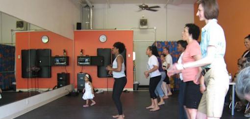 A group of people are dancing in a studio.