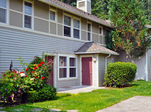 A house with a red door and a small porch.