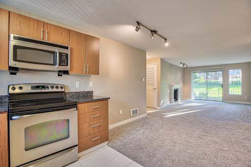 A kitchen with a stove top oven and microwave above it.