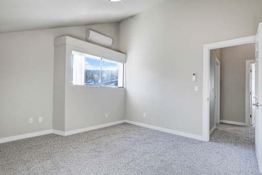 A room with a window and a door.