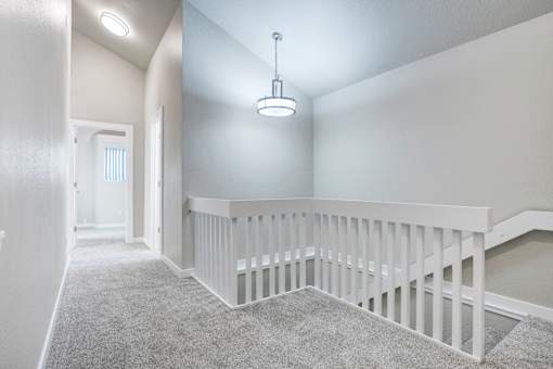 A white staircase with a carpeted floor.