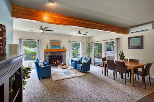 A living room with a fireplace and blue chairs.
