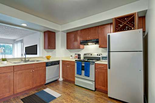 A kitchen with wooden cabinets and a white refrigerator.