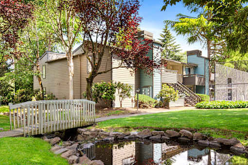 A house with a small pond in front of it.