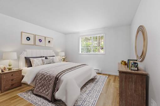 A bedroom with a large bed and a wooden dresser.