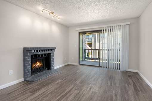 A room with a fireplace and sliding glass doors.