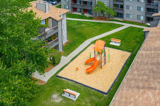 A playground with a slide and a sandbox.