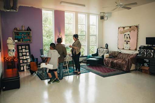 a group of people standing in a living room