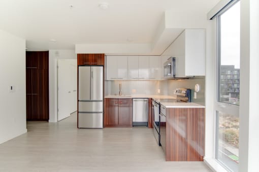 a kitchen with white cabinets and a stainless steel refrigerator