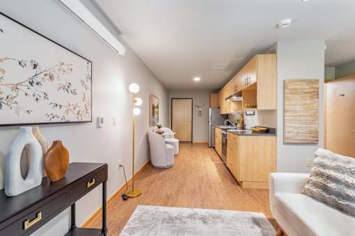 A modern kitchen with a dining area and a living room.