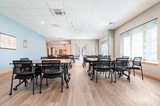 A conference room with a long table and chairs.