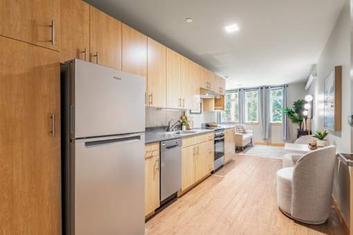 A modern kitchen with wooden cabinets and stainless steel appliances.