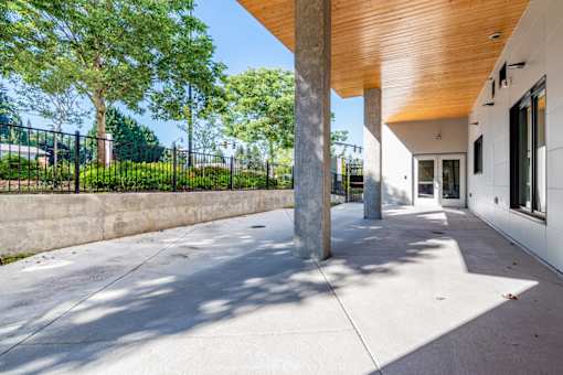 A modern building with a wooden roof and a concrete floor.