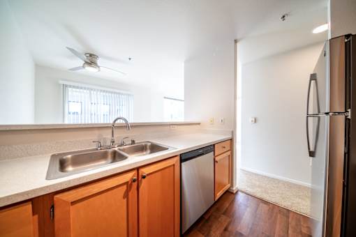 A kitchen with a sink and a refrigerator.