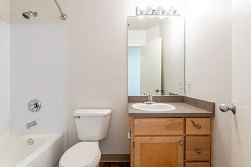 A white toilet sits next to a sink in a bathroom.
